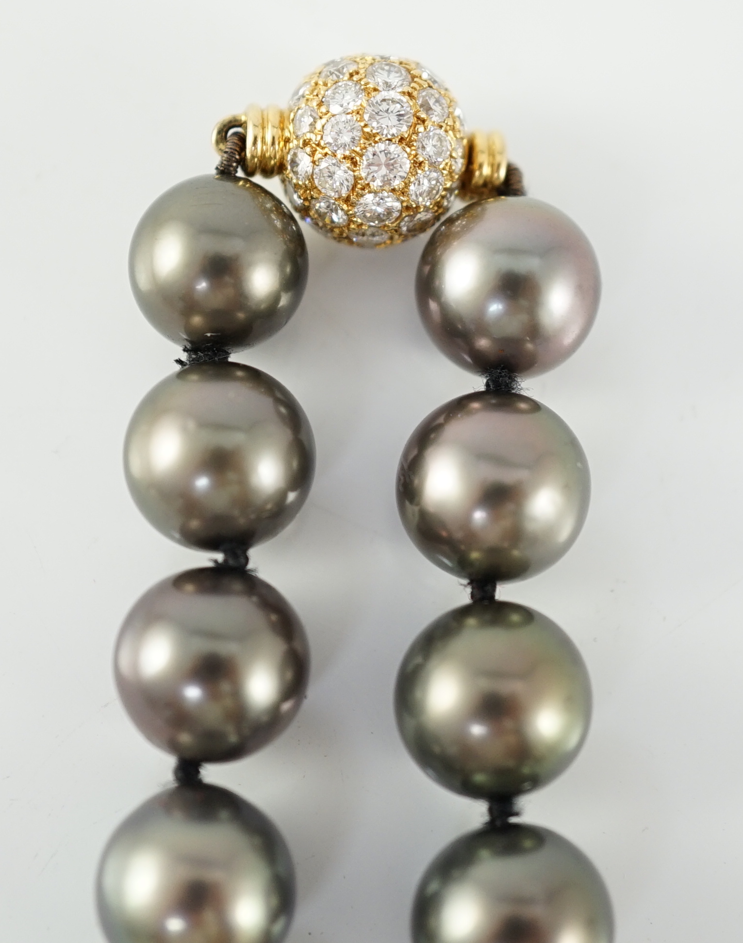 A modern Cartier single strand Tahitian pearl necklace, with 18ct gold and pave set diamond spherical clasp